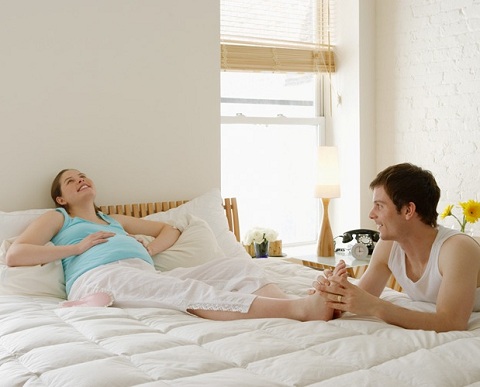 Man massaging pregnant partners foot